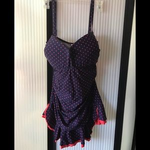 Coral polka dot skirted swimsuit. Dark blue body.